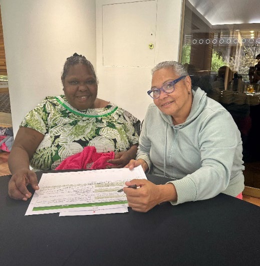Olga George and Vanessa Deakin looking at information about food security.