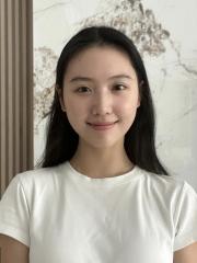 Student Ruyi Yu standing in front of a white marble background.