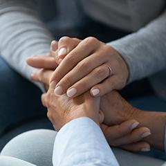 Two sets of hands holding each other