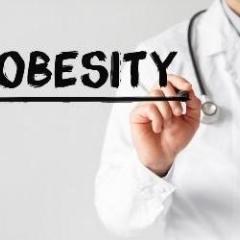 Doctor writing the word obesity