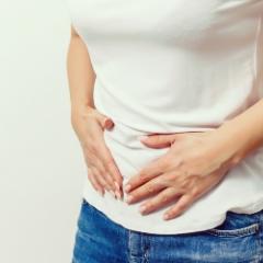 Woman clutching at stomach region
