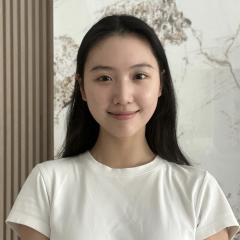 Student Ruyi Yu standing in front of a white marble background.