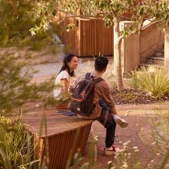 Two student sitting in the Reconciliation Garden