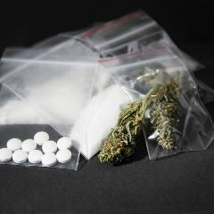 several small sealed bags of drugs and pills